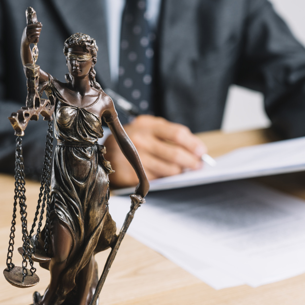 close-up-themis-lady-justice-holding-scale-front-lawyer-working-desk_23-2147898349