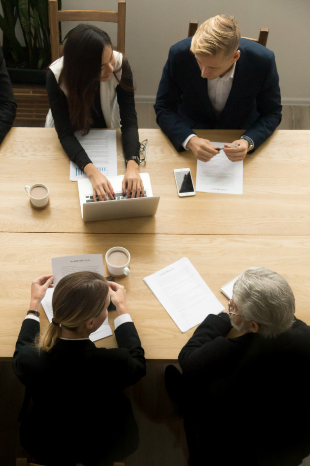 diverse-business-colleagues-working-together-meeting-vertical-top-view_1163-4889